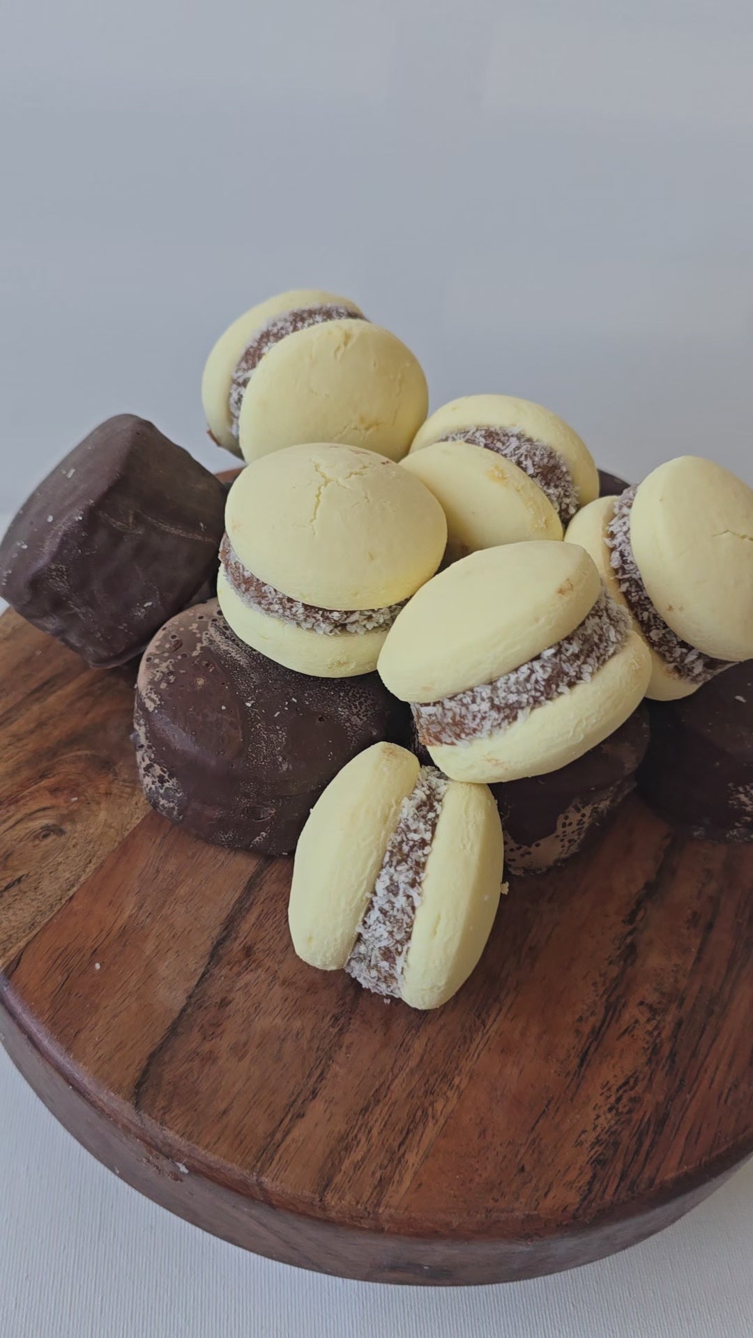 Traditional dulce de leche alfajor cut in half showing its soft crumb and rich filling.